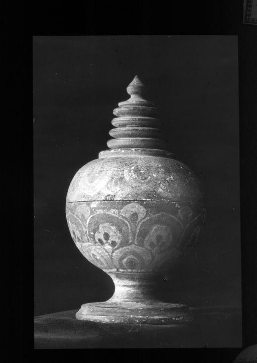 T 404: Runde gedrehte und mit Lotosblättern bemalte Urne mit Fuß und Deckelverzierung= Stūpaschirme